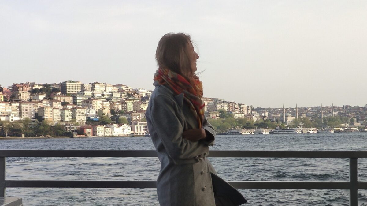 A Girl in Istanbul on a Bosphorus cruise with the view of the Asian shore