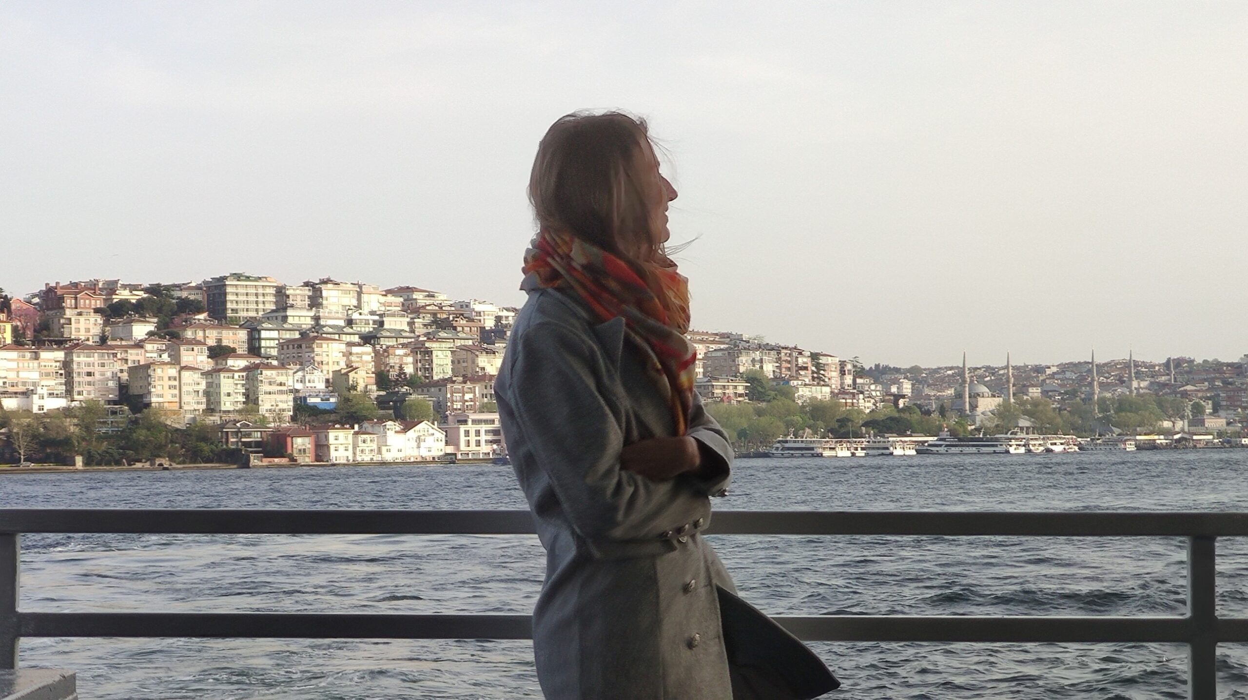 A Girl in Istanbul on a Bosphorus cruise with the view of the Asian shore
